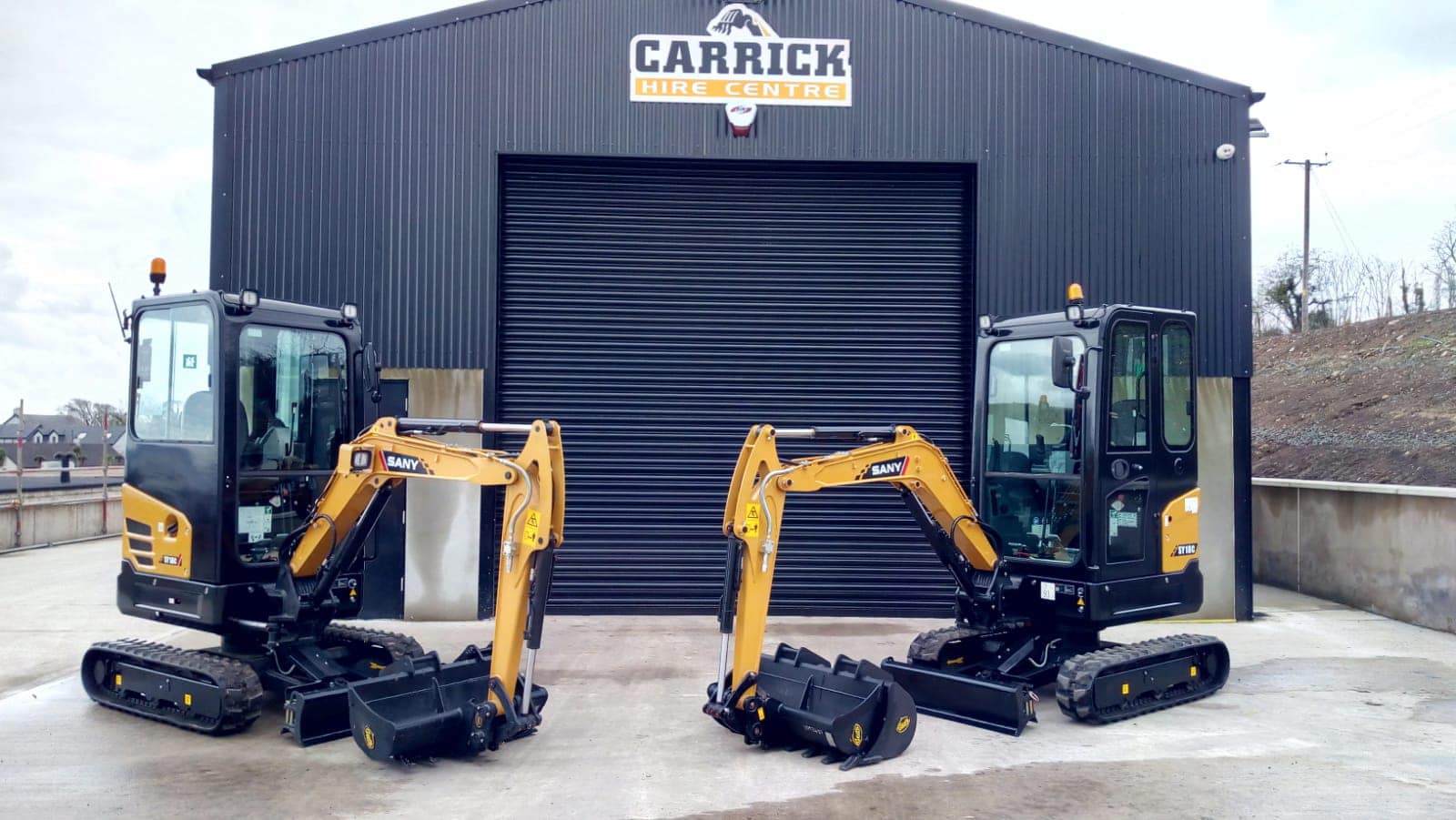 Mini Excavators in from of the Carrick Hire Centre Building | | Plant & Machinery Hire | Plant & Tool Hire | Machinery Repairs | Garden Tool Repairs | Belfast | Carrickfergus | Northern Ireland
